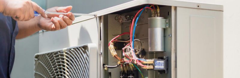 Furnace technician repairing a heating system in Rancho Santa Fe CA